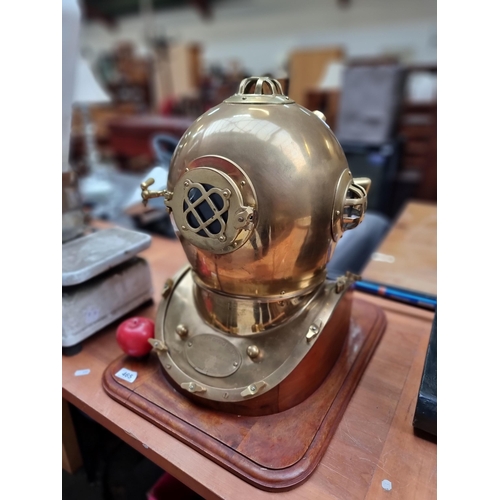 465 - Star Lot : A magnificent large replica of a solid brass U.S. Navy diving helmet sat on a wooden base... 