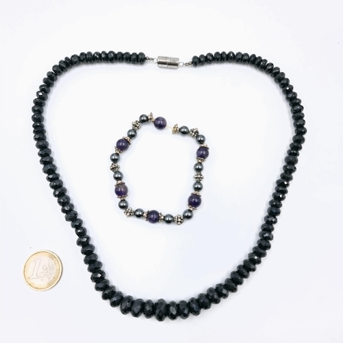 564 - A graduated vintage mourning black onyx stone necklace with silver magnetic clasp. Length of necklac... 