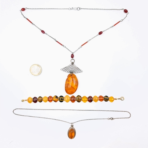 567 - Three Piltic amber items consisting of two necklaces. lengths of chain 52cms & 44 cms. Together with... 