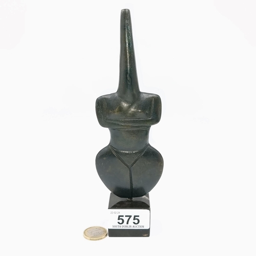 575 - A tribal violin shaped solid bronze statue. Length is 20 cms. Weight is 630 grams.