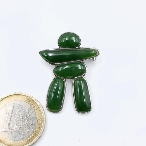 577 - A Sterling Silver polished green Jade  figure brooch set with pin intact in velvet pouch. Stones col... 