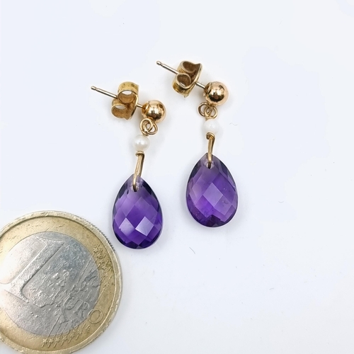 584 - A super pair of nine carat gold amethyst stone and pearl drop earrings. Weight is 1.8 grams.