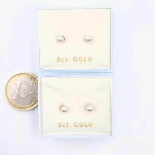 586 - Two pairs of nine carat gold pearl stud earrings.