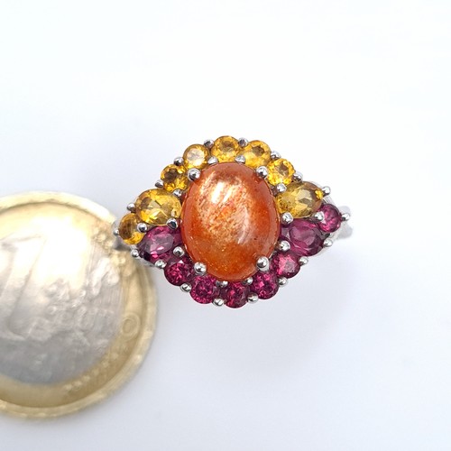 12 - Star Lot : A fabulous nine carat white gold Citrine and Amethyst ring set with a cabochon central st... 