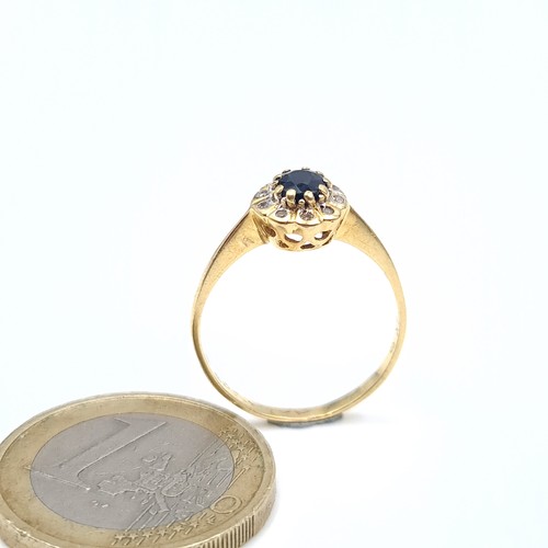 15 - Star Lot : A nice example of an 18 carat gold diamond and sapphire cluster ring. Ring size - N.Weigh... 