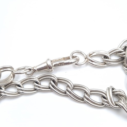 23 - A sterling silver chain link bracelet set with lobster clasps. Weight - 11.76 grams.