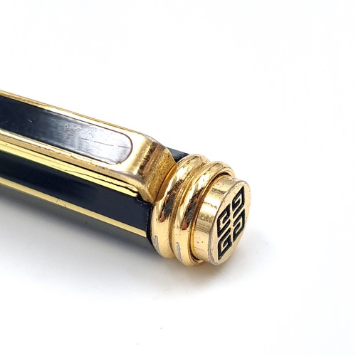 504 - An as new propelling pencil by Givenchy set with gold metal markings. Presented in box.