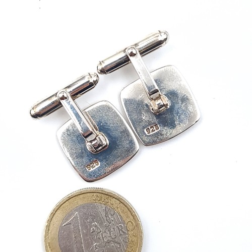 505 - A pair of sterling silver cuff links set with polished satin design. Total weight - 10.5 grams.