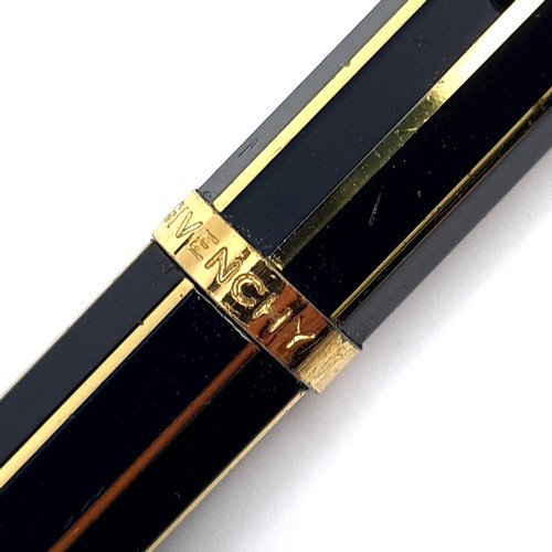 504 - An as new propelling pencil by Givenchy set with gold metal markings. Presented in box.