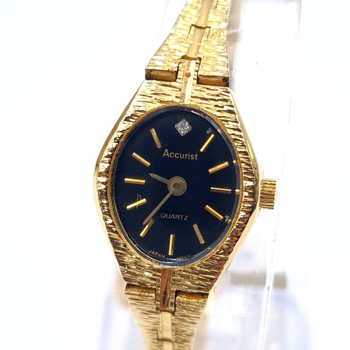 513 - An as new accurist gold toned quartz wrist watch with black dial and pattern hands together with bra... 