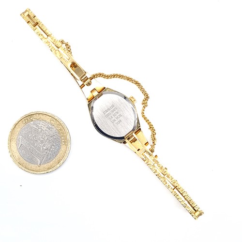 513 - An as new accurist gold toned quartz wrist watch with black dial and pattern hands together with bra... 