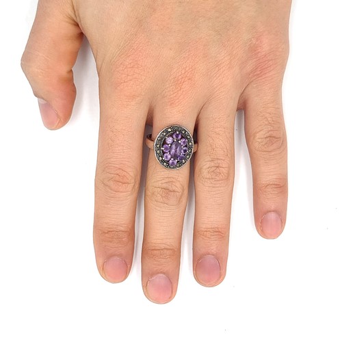 528 - A vintage amethyst and marcasite stone ring. Size - Q. Weight - 6.05 grams.