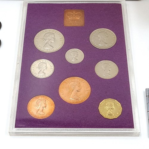 569 - A collection of coins and medallions In a cigar box.