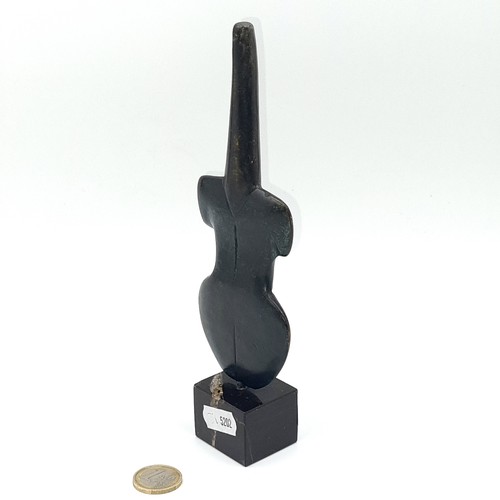 575 - A tribal violin shaped solid bronze statue. Length is 20 cms. Weight is 630 grams.