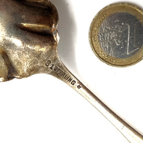 579 - A sterling silver preserve spoon with intricate detailing to bowl together with bright cut detailing... 