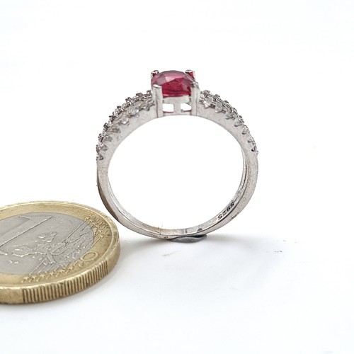 587 - A Sterling Silver red stone ring with white sapphire mount. Ring size - O. Weight 2.68 grams.