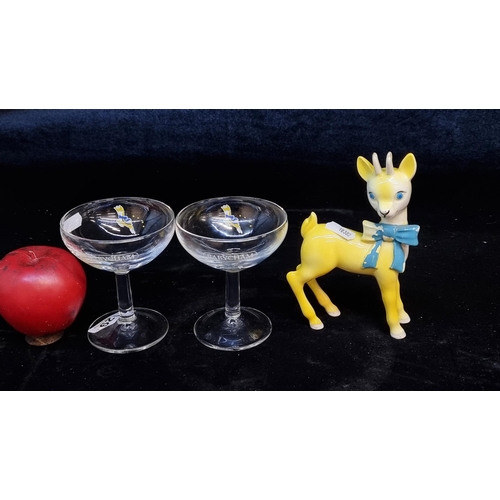 129 - Three highly collectable Babycham items including two branded Babycham glasses / coupes and a 1980's... 