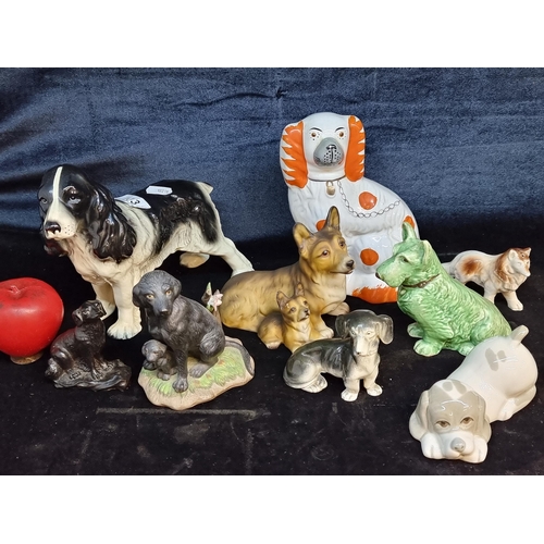 133 - A charming collection of 10 dog figurines including a beautiful black and white spaniel and a Wally ... 