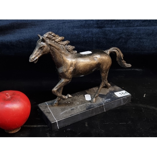 164 - A fantastic heavy bronze sculpture of a galloping horse sat on a cold marble base.