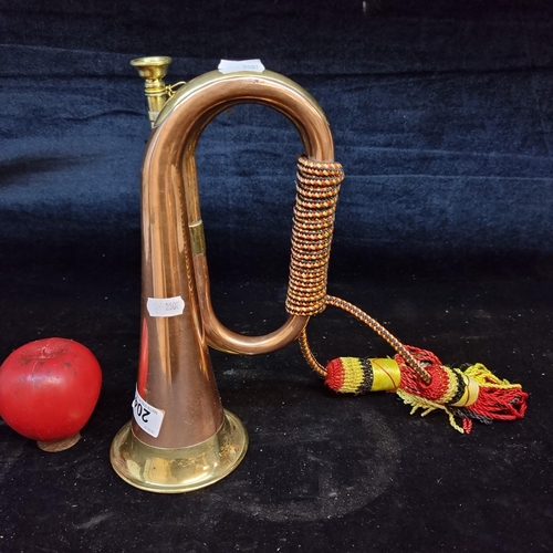 204 - A charming brass and copper bugle with braided cord detailing.