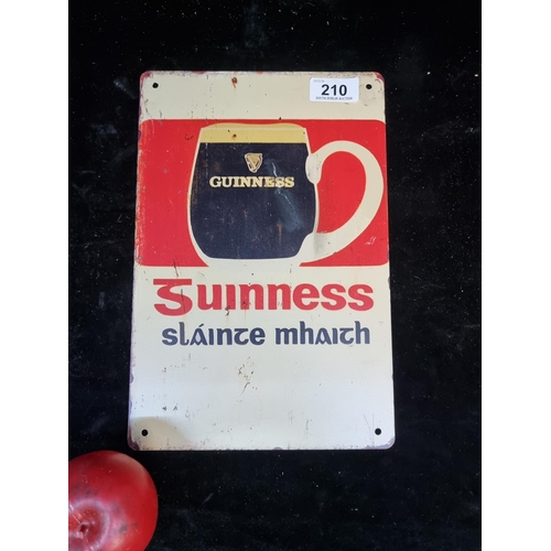 210 - A printed metal wall sign advertising Guinness.