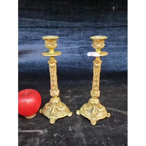 212 - A pair of vintage brass candle sticks Grecian column forms.