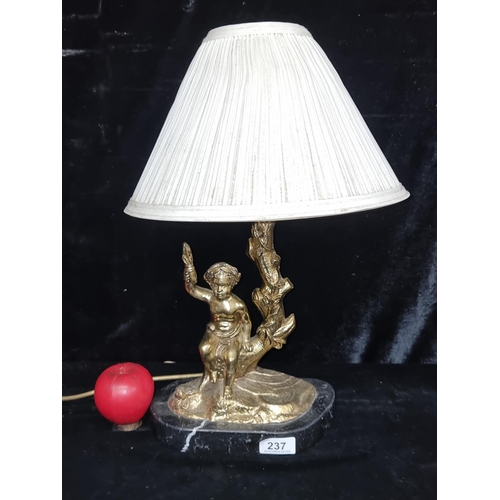 237 - A gorgeous solid brass table lamp depicting a young child sat on a tree. Sat on a black marble base.