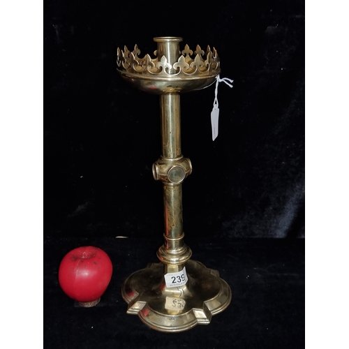 239 - A wonderful antique ecclesiastical themed tall brass candle holder with fleur-de-lis motifs to top r... 