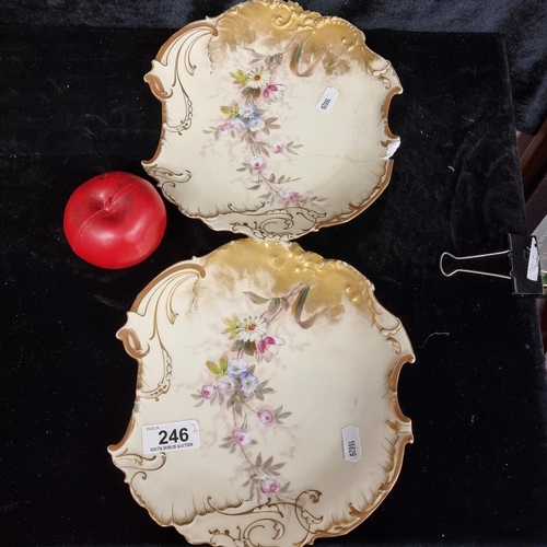 246 - A pair of elegant antique hand painted French Limoges blush plates boasting floral and gilt design. ... 