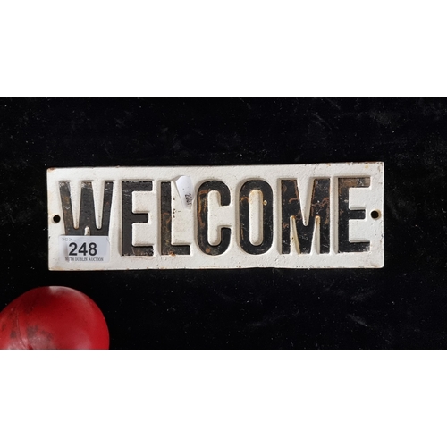 248 - A heavy cast metal welcome plaque.