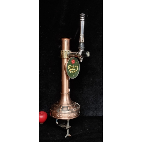 293 - A heavy copper  Carlsberg counter clamped beer tap with handle and flow control.