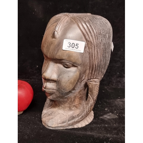 305 - A superb heavy African tribal bust of a young female.