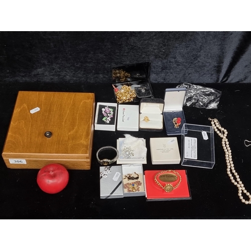 306 - A box containing a nice selection of costume jewellery including a watch, broaches and bracelet. Tha... 