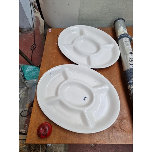 419 - A pair of very large ceramic serving platters in a cream glaze finish.