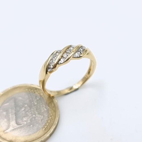 509 - Star Lot : A 14 carat gold twist set channel cut diamond ring. Size - O. Weight - 2.52 grams.