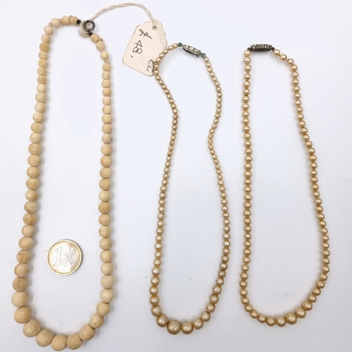 513 - A Victorian graduated Bone necklace. Length - 44 cms. Weight - 27.66 grams. Together with two lustre... 