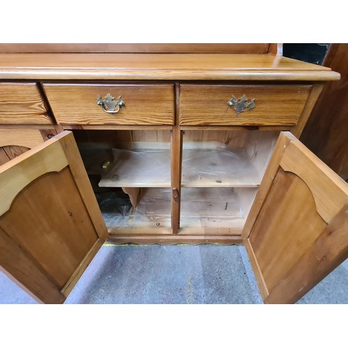 422 - Star Lot : A super large antique pine dresser featuring lots of storage space and attractive brass p... 