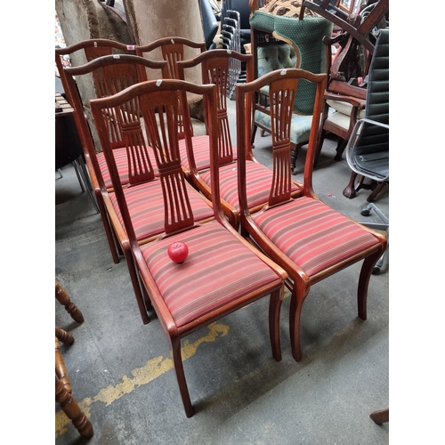 1012 - A set of 6 red mahogany dining chairs with classic striped upholstery, exuding sophistication and du... 