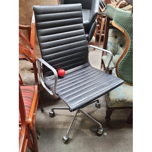 1014 - Star Lot : A stylish IFC Charles Eames black leather leather office chair featuring a chrome base an... 