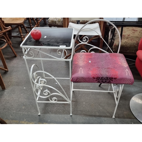 1017 - Elegant wrought iron vanity set, featuring a glass-topped table and cushioned chair with a floral pa... 