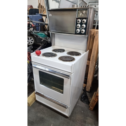 1026 - A super 1974 vintage electric cooker, classic white finish, featuring four burners and a single oven... 