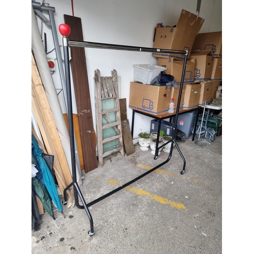 989 - A large high quality commercial metal clothing rail, held on castors. Ideal for personal or commerci... 