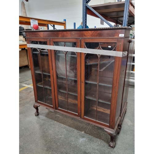 999 - A timeless mahogany display cabinet / bookcase  with clawed feet and leaded glass, exuding period el... 