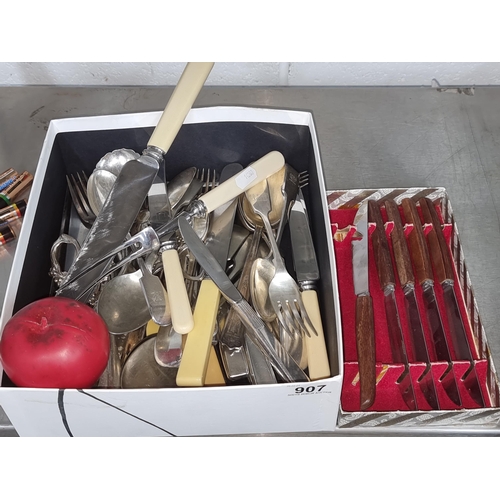 907 - A large quantity of vintage cutlery including knives, EPNS forks and spoons, wooden handled steak kn... 