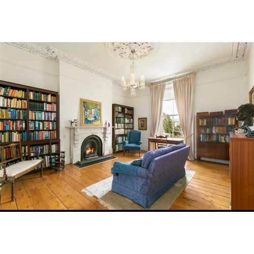 998 - Star Lot : A timeless mahogany bookcase, featuring glass doors and ample storage space, ideal for so... 