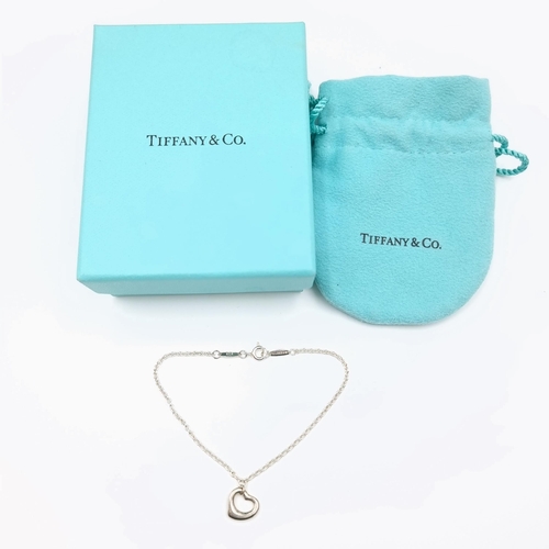 1031 - An original Tiffany and Co Elsa Peretti Open Heart Bracelet in Silver with original box and dust bag... 