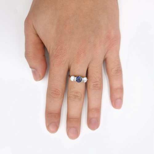 34 - A very pretty three stone Tamnzanite and gemstone ring. Size - O and a half. Weight is 2.7 grams.