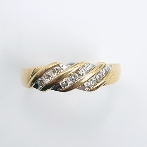 509 - Star Lot : A 14 carat gold twist set channel cut diamond ring. Size - O. Weight - 2.52 grams.