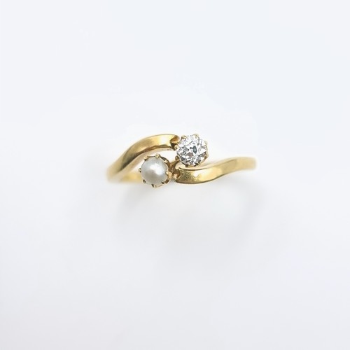 511 - An unmarked 9 carat gold diamond and pearl ring set on twist mount. Size - J 1/2. Weight - 2.86 gram... 