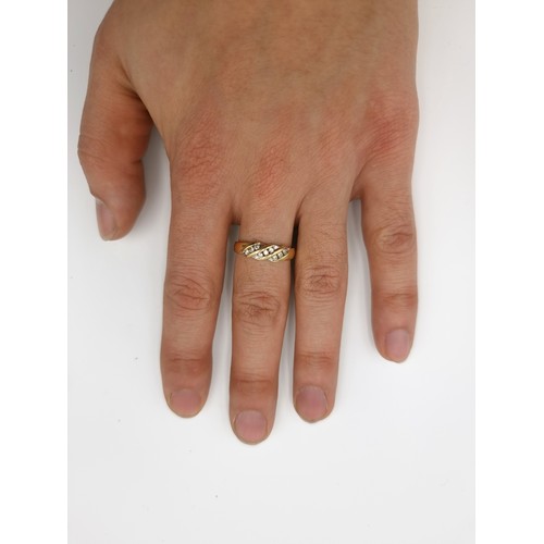 509 - Star Lot : A 14 carat gold twist set channel cut diamond ring. Size - O. Weight - 2.52 grams.